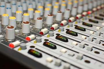 Close up shot of buttons, dials and controls of sound board