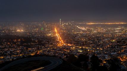 Wide View of San Francisco Skyscrappers at Night From High Ground