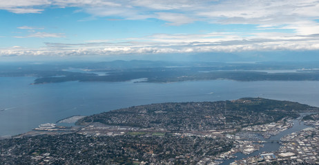 Fototapeta na wymiar Aerial View of the Seattle Bay from Airplane With Cloudy Day