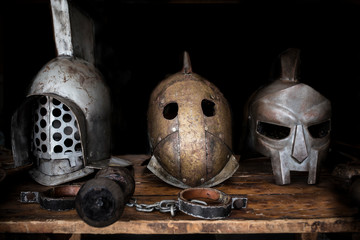 Gladiators table with helmets, swords and shakles