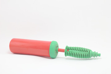 A small, colorful portable balloon pump.