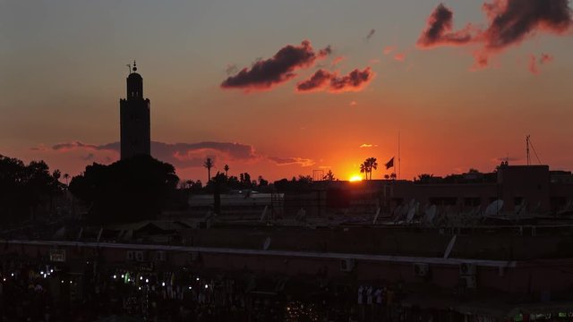 Famous Jemaa el Fna square crowded at sunset, Marrakesh, Morocco, timelapse 4k