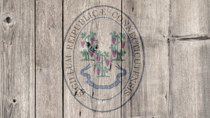 USA Politics News Concept: US State Connecticut Seal Wooden Fence Background