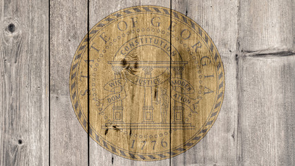 USA Politics News Concept: US State Georgia Seal Wooden Fence Background