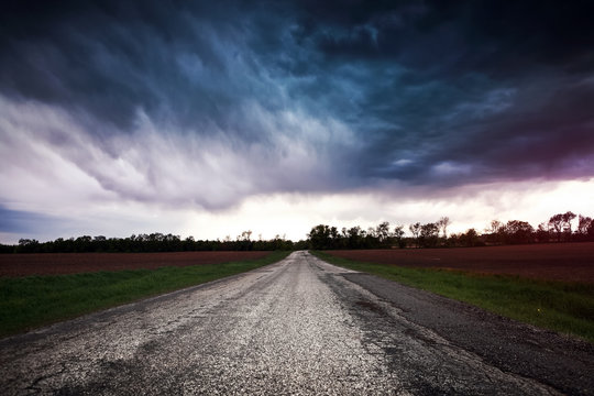 Storm clouds over a country road