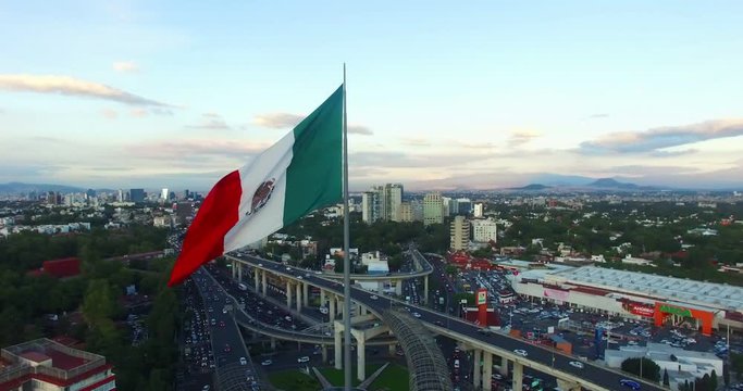 Aerial view of a huge mexican flag fluttering, Mexico City. TK9