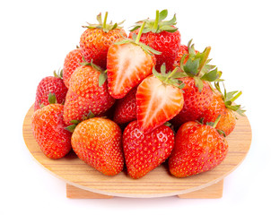 Heap of fresh strawberries in ceramic bowl  on the wooden tray.
