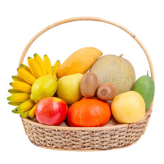 Composition with assorted fruits in wicker basket, balanced diet on white wood background