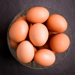 Fresh farm eggs on black stone background,top view with copy space