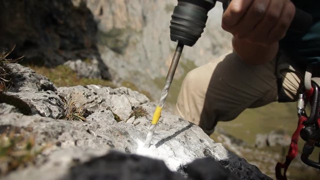 Close-up of the hammer drill a hole in the rock.