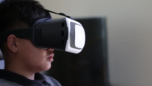 Young boy wearing virtual reality headset on digital screen. Vr is interactive computer-generated experience taking place within simulated environment. Visual future technology concept.