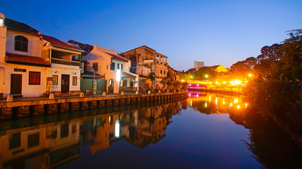 Fototapeta premium Mirror reflection od historical building in Malacca Riverside during blue hour before sunrise.