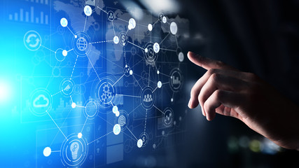 Mixed media. Business Organisational structure on virtual screen with process icons.