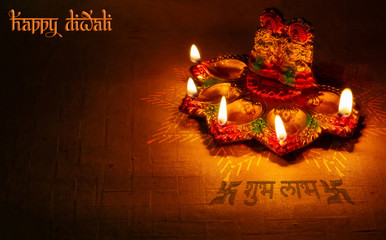 Diwali decorative clay lamp with idols of Lord Ganesha and Laxmi and traditional greetings in hindi font. © Roop Dey