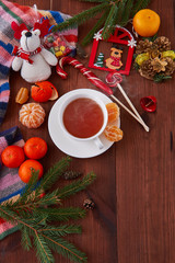 Christmas breakfast. Hot cup of tea on a wooden table. Winter morning. Marry chrismas and happy new year. Composition from above. Good atmosphere. 
