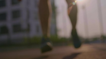 Young male player dribbles ball in crouched position. Single handling practicing before tournament on the urban area in downtown. Man enjoy the basketball at evening summertime holiday near with home - Powered by Adobe