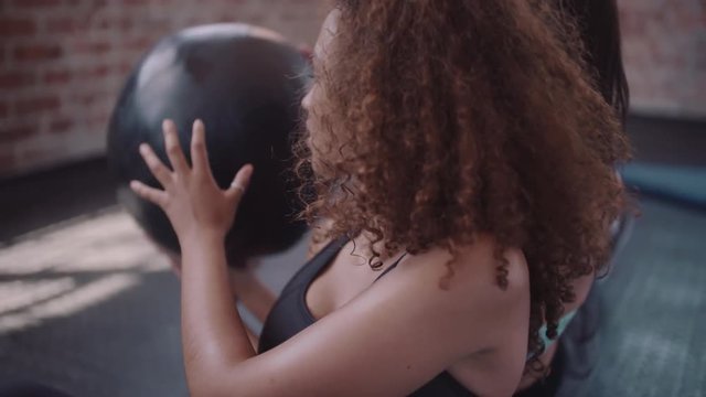 Women working out at gym with fitness ball
