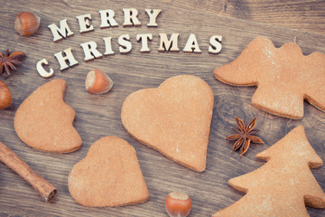 Gingerbreads, inscription Merry Christmas and ingredients for baking. Vintage photo
