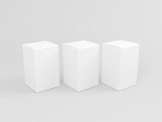Three White cardboard boxes mockup isolated on gray