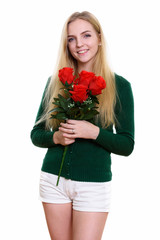 Studio shot of young happy teenage girl smiling while holding re