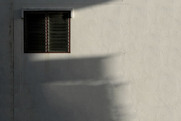 The old louver window with hard light