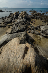Fototapeta na wymiar The rock on the beach with daylight