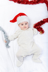 beautiful baby boy in christmas hat lying