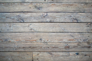 Old wooden gray flooring with knots and cracks, may be used as background