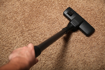 Carpet and vacuum cleaner. Apartment cleaning.