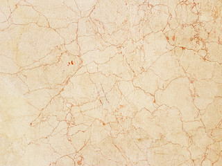 Naklejka premium The plate is made of yellow marble with a red streaks. brownish-white shades. Smooth texture for design and decoration. Natural building material. Natural patterns on the stone. Plates for floor and
