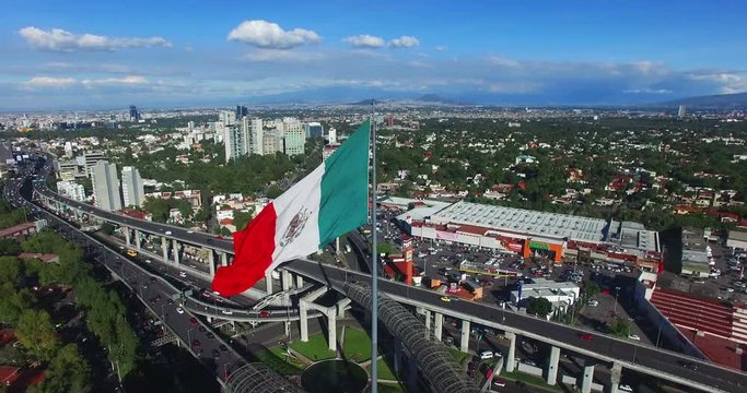 Aerial view of a huge mexican flag fluttering, Mexico City. TK5