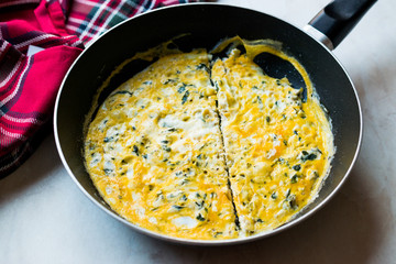 Half Cut Omelette with Cream Cheese and Chives in Pan.