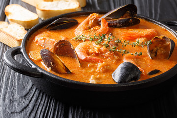 Catalan authentic spicy Suquet de Peix soup with potatoes, shrimps, mussels, herbs and fish with...