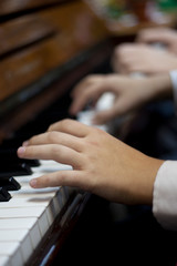 Children play piano in four hands