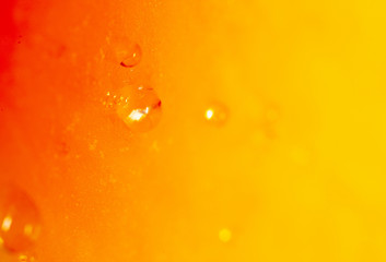 Drops of juice on pumpkin pulp as abstract background