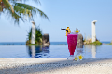 dragon fruit juice in a glass by the pool