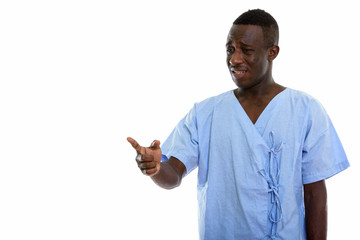 Studio shot of young black African man patient looking sad while
