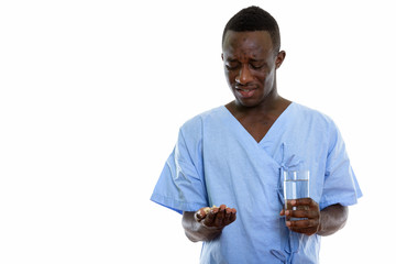 Studio shot of young disgusted black African man patient looking