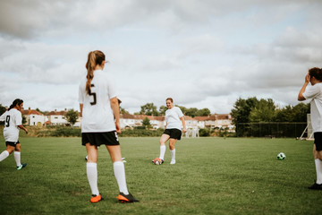 Female football players training on the field
