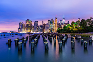Fototapeta na wymiar Manhattan panoramic skyline at night. New York City, USA. Office buildings and skyscrapers at Lower Manhattan (Downtown Manhattan)..