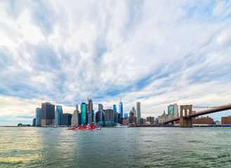 Manhattan panoramic skyline with Brooklyn Bridge. New York City, USA. Office buildings and...