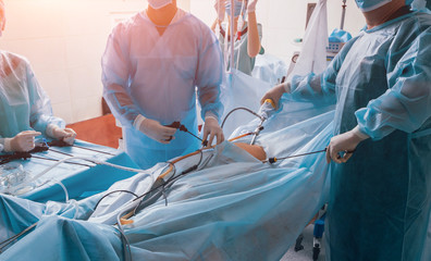 Process of gynecological surgery operation using laparoscopic equipment. Group of surgeons in...