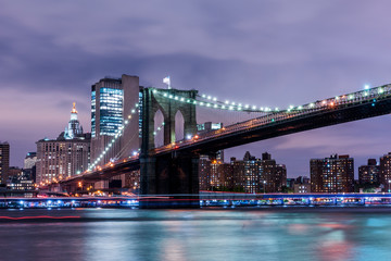 Fototapeta na wymiar Brooklyn Bridge at sunset view. New York City, USA. Brooklyn Bridge is linking Lower Manhattan to Brooklyn..