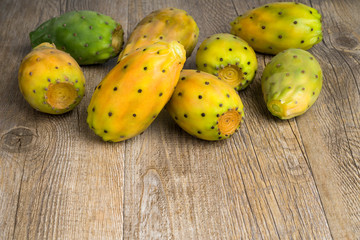 Prickly pears on old wooden table