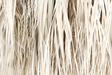 Old weathered coconut leaf roof of hut. Dried banana palm leaves background. Dried palm leaves texture. Close up organic gray palm leaves pattern background and texture. Abstract background.