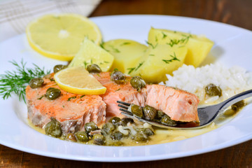 Pan seared salmon with lemon garlic caper butter sauce. Salmon piccata with rice and boiled potatoes.