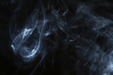 nice abstract light bright smoke on the heavy black background.