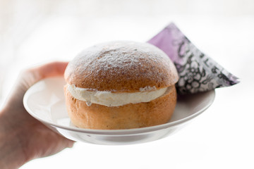 Closeup of delicious swedish cream bun on a plate