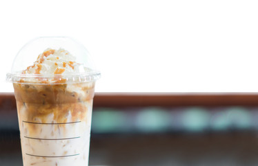 Ice coffee and whipped cream with caramel sauce on white background