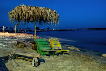 Bench on the night shore of the sea.